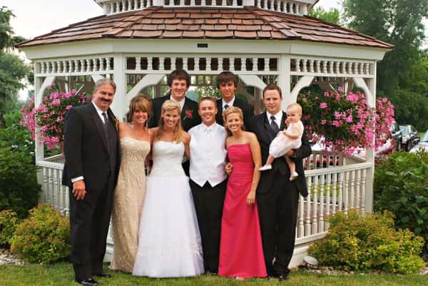 group shot of family posing for a picture infront of a gazebo