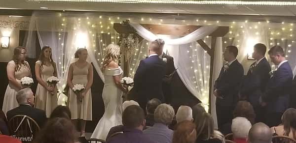 bridge and groom wedding ceremony with lights and decor