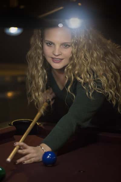 a woman playing pool