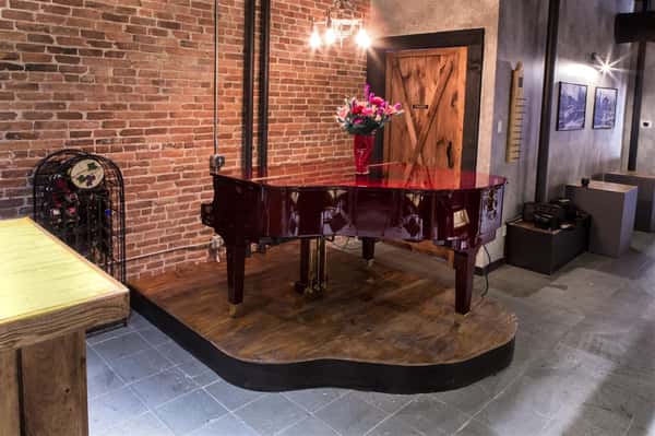 a piano with a decorative vase of flowers