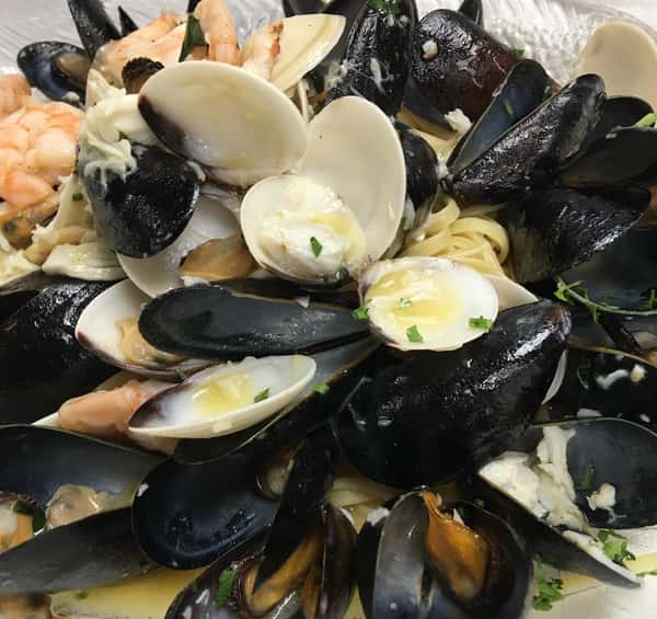 Seafood Vesuvio: Shrimp, Scallops, and Lump Crabmeat, Served over a Bed of Linguini