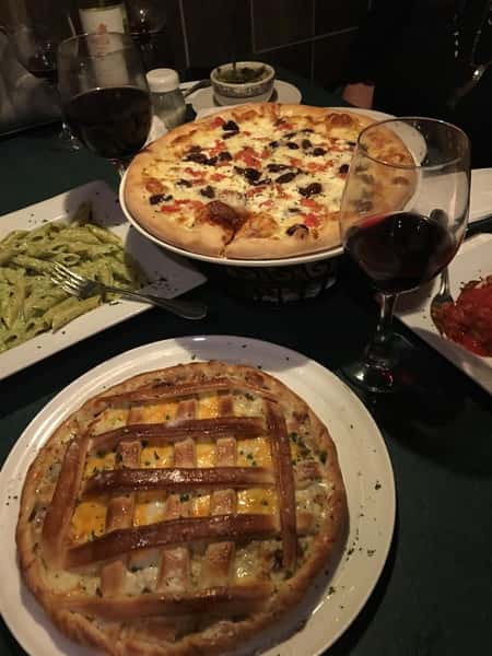 assorted pizzas and pastas on a table