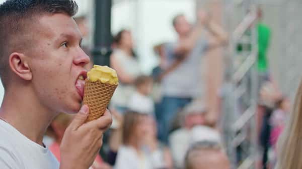 a man eating an ice cream in a cone
