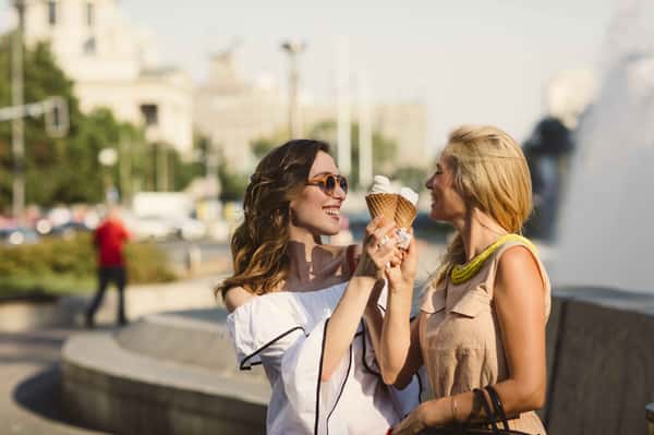 two people holding ice creams