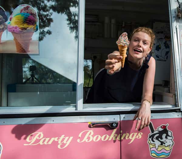 woman offering ice cream inside a food truck