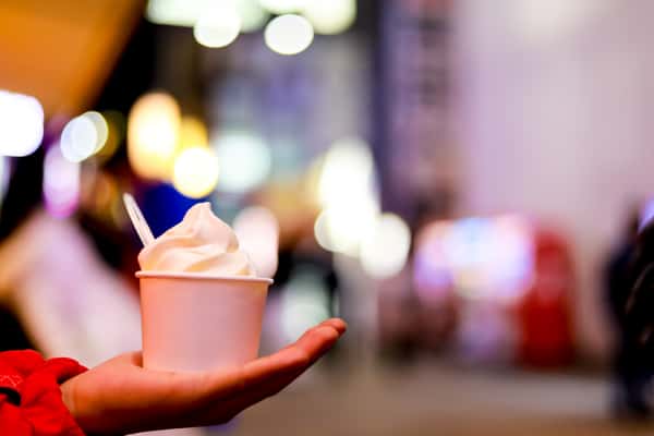 soft serve swirls in a cup held in one hand