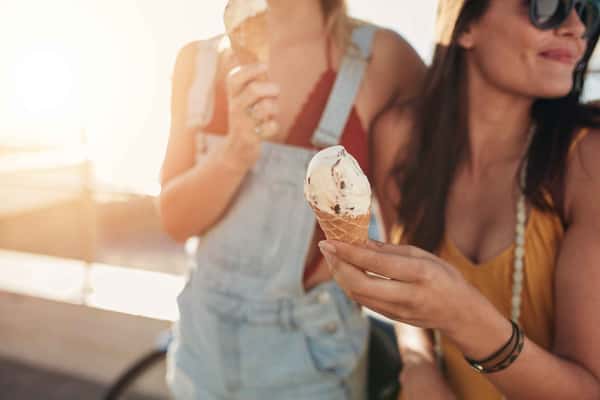 two women holding ice creams