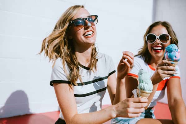 two women holding ice creams