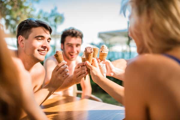 a group of people holding ice creams