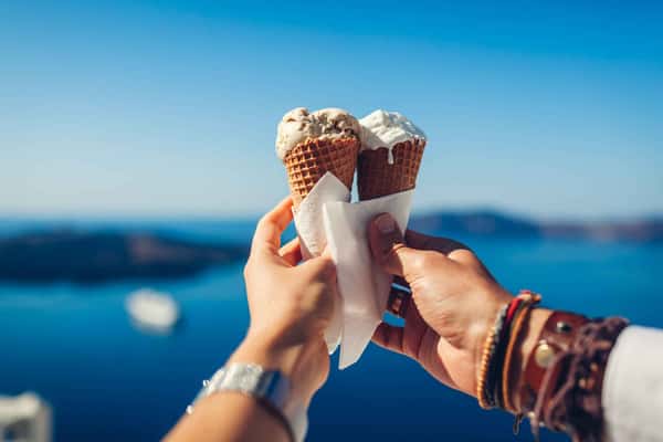 two hands holding an ice cream each beside each other