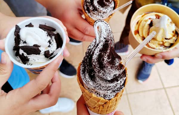 four different ice creams being held