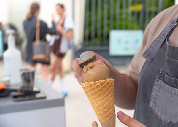 scooping ice cream into a cone