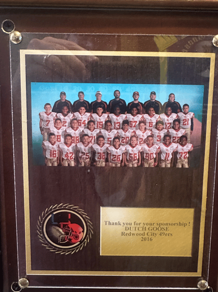 Framed plaque featuring Redwood City 49ers youth football team photo and engraved message thanking Dutch Goose for sponsorship in 2016