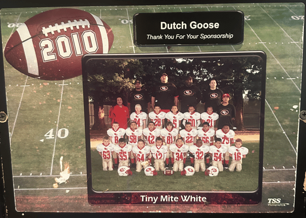 Plaque featuring 2010 football graphic and Tiny Mite White team photo, thanking Dutch Goose for sponsorship