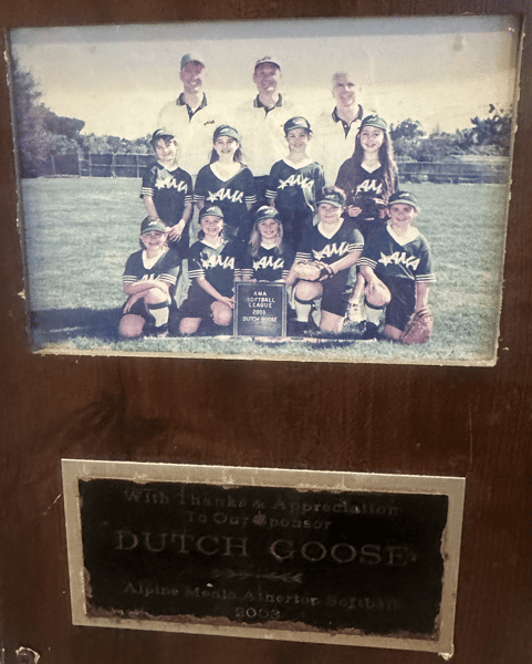 Framed vintage youth softball team photo with AMA uniforms on a grassy field, labeled AMA Softball League 2003 Dutch Coose.