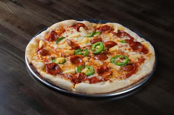 Pepperoni and pineapple pizza topped with fresh jalapeño slices and melted mozzarella on a hand-tossed crust, served on a metal pan – sweet and spicy specialty pizza perfect for a modern pizzeria or casual Italian restaurant menu.