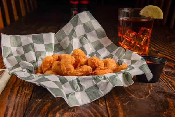 Golden fried shrimp basket lined with paper and paired with cocktail sauce at Blackwell Revival in Atkins, Arkansas