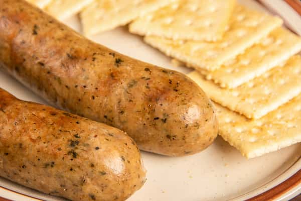 Close-up of Cajun boudin sausage links served with crackers at Blackwell Revival in Atkins, Arkansas