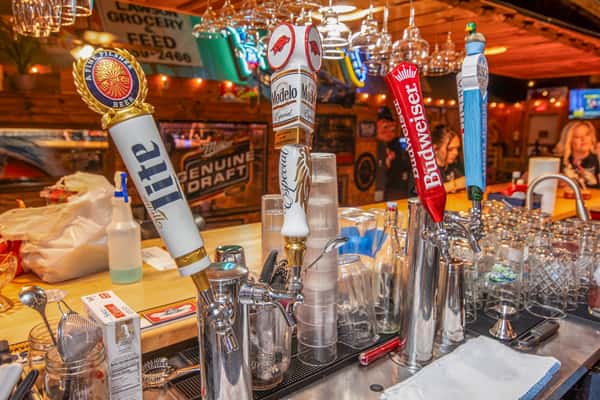 Full-service bar with beer taps and glassware at Blackwell Revival in Atkins, AR, showcasing a lively Cajun American dining atmosphere