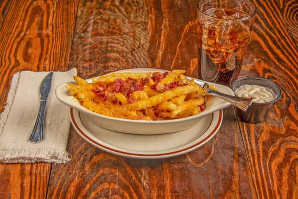 Loaded Texas cheese fries with melted cheddar, bacon, and Cajun seasoning at Blackwell Revival in Atkins, AR
