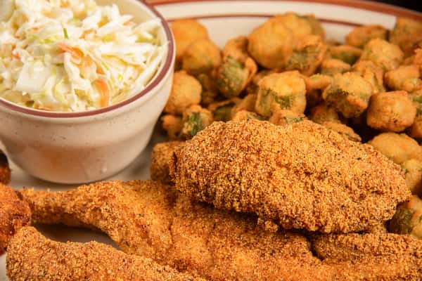 Close-up of crispy fried catfish fillets with hushpuppies and coleslaw at Blackwell Revival in Atkins, Arkansas