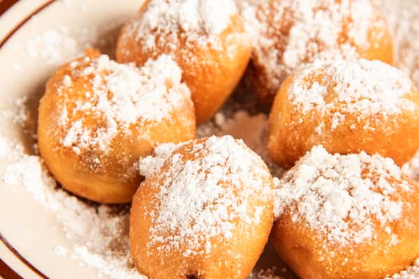 Close-up of chocolate-filled beignets dusted with powdered sugar at Blackwell Revival in Atkins, Arkansas