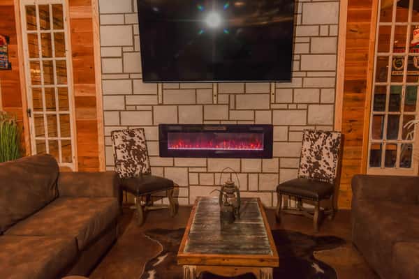 Cozy lounge area with fireplace and seating at Blackwell Revival in Atkins, AR, offering a relaxed dining and social atmosphere