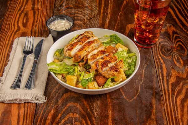 Grilled chicken Caesar salad with romaine, croutons, and dressing at Blackwell Revival in Atkins, AR