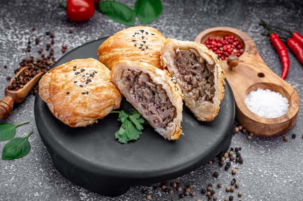 Traditional samsa pastry stuffed with seasoned beef at Laghman Express