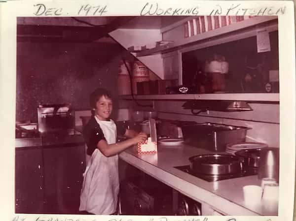 young boy working in kitchen