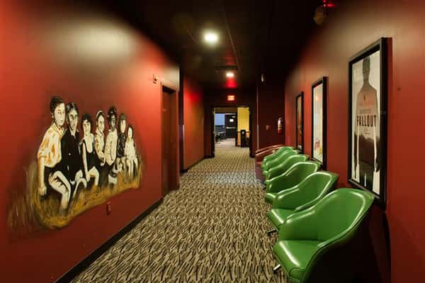 outside of movie theater with a row of chairs