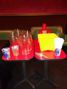 tray of empty cups and empty beer pitchers