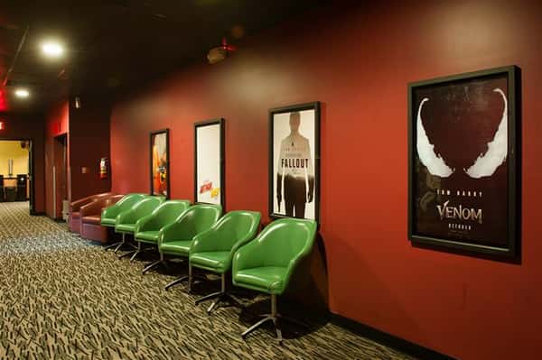 outside of movie theater with a row of chairs