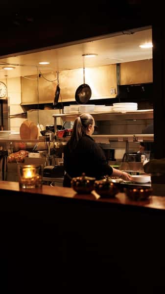 Open kitchen and chef's counter at EVO Old Town Scottsdale showcasing a modern dining atmosphere and culinary craftsmanship.