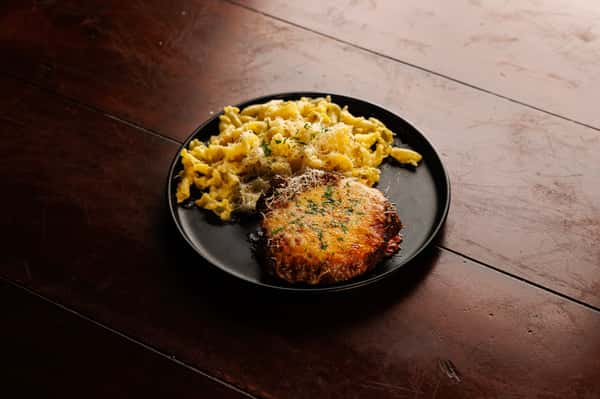 Baked macaroni and cheese topped with a golden herb crust, served in a cast-iron skillet at EVO North Scottsdale.