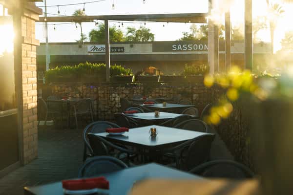Outdoor patio dining at EVO Old Town Scottsdale featuring stylish seating, string lights, and a relaxed evening atmosphere.
