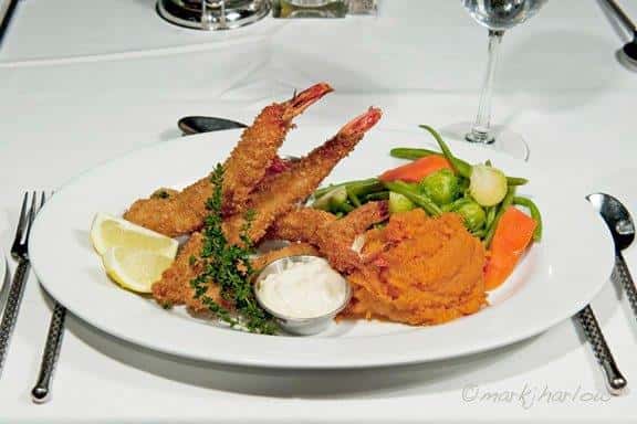 Golden Fried Prawns. Hand breaded jumbo shrimp, fried and served with cocktail and tartar sauce, house vegetable and mashed sweet potatoes
