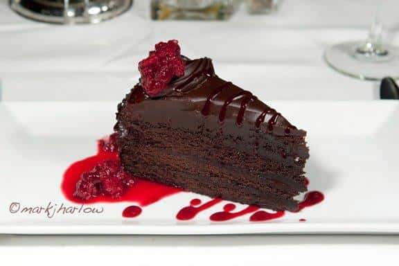 chocolate cake topped with raspberries