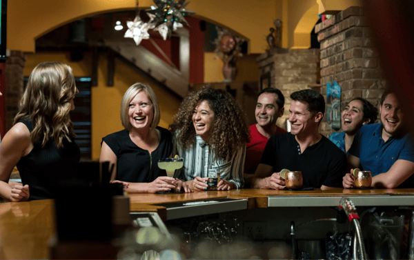 people laughing at bar