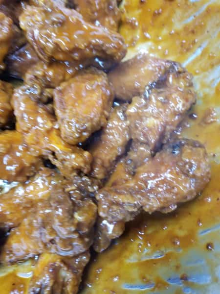 chicken wings on the bone covered in sauce