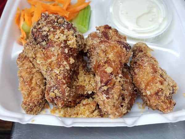 chicken wings on the bone with breadcrumbs, a side of ranch, shredded carrots, and celery