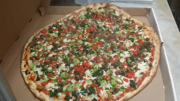 Vegetable pizza with cheese, broccoli, tomatoes, and mushrooms