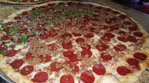 Pepperoni pizza with meatball crumbles and slices of broccoli