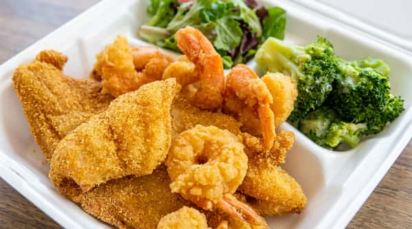 Fried shrimp and fish fillets with a side of broccoli and lettuce on a white plate.