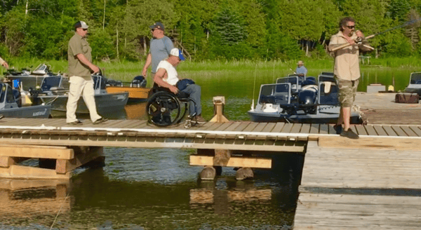 man in a wheel chair on a dock