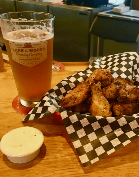 basket of wings with dipping sauce and a beer
