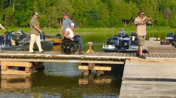 man in a wheel chair on a dock