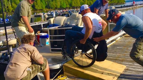 man in a wheel chair on a dock