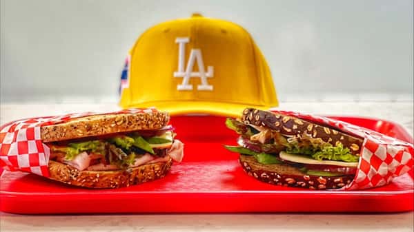la hat with sandwiches in front