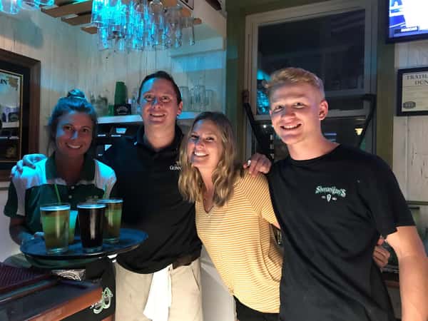 Employees smiling and working at the bar